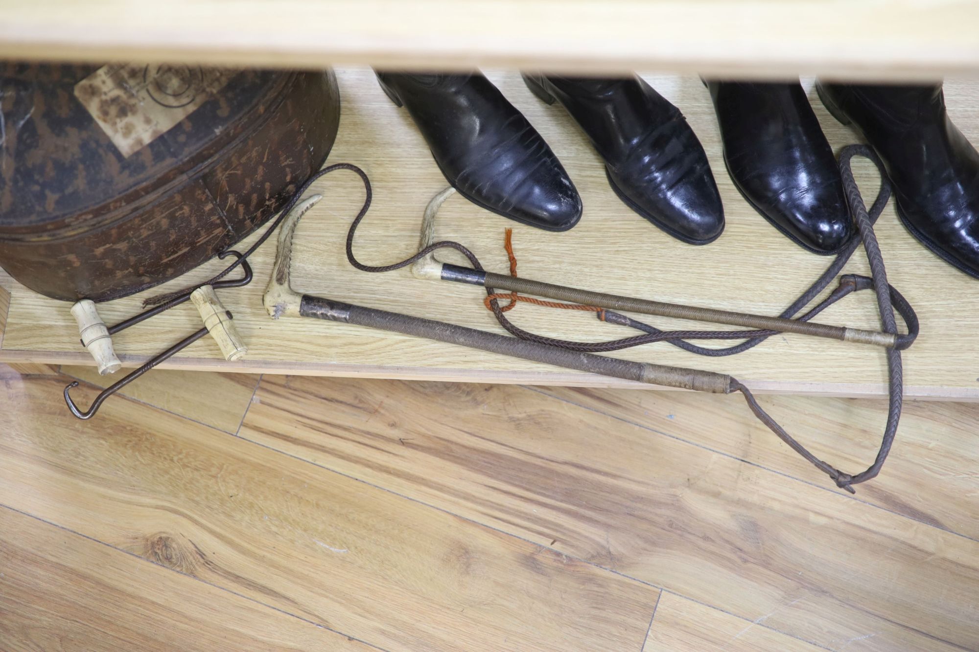 Two pairs of riding boots and trees together with two boot pulls and riding crops and a toleware hat box